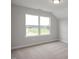 A light-filled bedroom with vaulted ceiling, a large window, and neutral carpet at 71 Priming Way, Angier, NC 27501