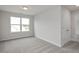 A gray bedroom featuring a large window offering natural light at 71 Priming Way, Angier, NC 27501