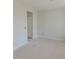 A bedroom with neutral paint and an attached entryway door, featuring simple trim at 71 Priming Way, Angier, NC 27501