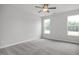 Spacious bedroom filled with neutral carpet and brightened by two large windows at 71 Priming Way, Angier, NC 27501