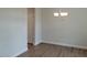 Clean dining room featuring hardwood floors, a modern chandelier, and neutral paint, perfect for gatherings at 71 Priming Way, Angier, NC 27501