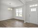 Inviting entryway featuring new hard wood floors, large windows, modern lighting and neutral paint at 71 Priming Way, Angier, NC 27501