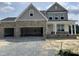 Charming two-story home featuring stone accents, a welcoming porch, and a convenient two-car garage at 71 Priming Way, Angier, NC 27501
