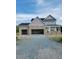 Charming two-story home with a large, unfinished stone driveway and a spacious three-car garage at 71 Priming Way, Angier, NC 27501