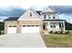 Charming two-story home featuring a three-car garage and a welcoming front porch, creating instant curb appeal at 71 Priming Way, Angier, NC 27501