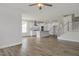 Modern kitchen boasts white cabinets, stainless steel appliances, a center island, and hardwood floors at 71 Priming Way, Angier, NC 27501