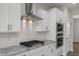 The kitchen boasts stainless appliances, a granite countertop and stylish tile backsplash at 71 Priming Way, Angier, NC 27501