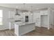 Gourmet kitchen features granite countertops, stainless steel appliances, a center island, and white cabinets at 71 Priming Way, Angier, NC 27501
