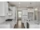 Bright kitchen features granite countertops, stainless steel appliances, and hardwood flooring at 71 Priming Way, Angier, NC 27501