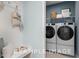 Conveniently located laundry room with modern washer and dryer, storage shelf, and hall tree at 71 Priming Way, Angier, NC 27501