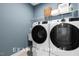 Close-up of a modern washer and dryer in a well-lit laundry room with storage at 71 Priming Way, Angier, NC 27501