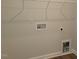 Functional laundry room featuring essential hookups and shelving for efficient organization at 71 Priming Way, Angier, NC 27501