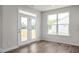 Bright living area featuring a glass door to the backyard deck, a large window, and light gray walls at 71 Priming Way, Angier, NC 27501