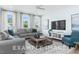 Bright living room featuring large windows, comfortable seating, and stylish decor accents at 71 Priming Way, Angier, NC 27501