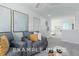 A living room featuring comfortable seating, modern decor, and view of a bedroom at 71 Priming Way, Angier, NC 27501