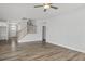 Spacious living room with hardwood floors, a ceiling fan, and staircase leading to the upper level at 71 Priming Way, Angier, NC 27501