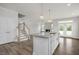 Open concept design with a view of the living room, fireplace, staircase, and outdoor access at 71 Priming Way, Angier, NC 27501