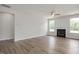 Bright and airy living room features a fireplace, large windows, and hardwood floors for a cozy ambiance at 71 Priming Way, Angier, NC 27501