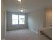 Carpeted loft space with natural light, perfect for a playroom, office, or additional living area at 71 Priming Way, Angier, NC 27501