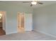 Serene main bedroom with carpet, neutral paint, and an open doorway to an en-suite bathroom at 71 Priming Way, Angier, NC 27501