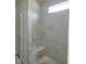 Modern shower with elegant white marble-style tiles, a built-in bench, and natural light at 71 Priming Way, Angier, NC 27501