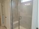 Modern shower with marble tile, a built-in bench, and a sleek glass door for a luxurious experience at 71 Priming Way, Angier, NC 27501