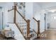 Elegant staircase with wood and white accents, creating a welcoming and bright entrance at 71 Priming Way, Angier, NC 27501