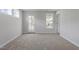 New carpet in this light and airy bedroom, featuring a door and two windows at 720 Georgias Landing Pkwy # 11, Raleigh, NC 27603
