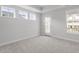 Bright bedroom with neutral walls, walkout to balcony, two windows and recessed lighting at 720 Georgias Landing Pkwy # 11, Raleigh, NC 27603