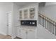 Charming butlers pantry featuring glass cabinets, navy subway tile backsplash and granite counters at 720 Georgias Landing Pkwy # 11, Raleigh, NC 27603