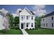 Two-story house with light beige siding, a front porch, and walkway at 720 Georgias Landing Pkwy # 11, Raleigh, NC 27603