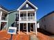 Two story home featuring a covered porch, multiple windows, and blue vinyl siding at 720 Georgias Landing Pkwy # 11, Raleigh, NC 27603