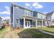 Exterior view of newly constructed home, highlighting the back patio and yard at 720 Georgias Landing Pkwy # 11, Raleigh, NC 27603