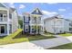 Attractive blue two-story home with a front porch and manicured lawn on a sunny day at 720 Georgias Landing Pkwy # 11, Raleigh, NC 27603