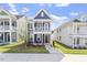 Charming blue two-story home with a front porch and manicured lawn under a clear sky at 720 Georgias Landing Pkwy # 11, Raleigh, NC 27603