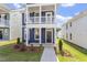 Close up of a blue two-story home featuring a cozy front porch and well-kept landscaping at 720 Georgias Landing Pkwy # 11, Raleigh, NC 27603