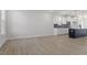 Bright living area with hardwood floors and a view into the kitchen featuring modern appliances at 720 Georgias Landing Pkwy # 11, Raleigh, NC 27603