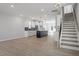 Bright open-concept living space with modern light fixtures, hardwood floors and black kitchen island at 720 Georgias Landing Pkwy # 11, Raleigh, NC 27603