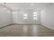 Bright living room featuring light wood floors, white walls, and natural light from the windows at 720 Georgias Landing Pkwy # 11, Raleigh, NC 27603