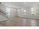 Bright and spacious living area with hardwood floors and large windows creating a warm atmosphere at 720 Georgias Landing Pkwy # 11, Raleigh, NC 27603