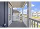 View from the covered porch showcasing neighborhood homes on a sunny day at 720 Georgias Landing Pkwy # 11, Raleigh, NC 27603
