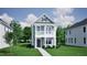 Two-story Craftsman style home with light green siding, and a walkway at 739 Georgia'S Landing Pkwy # 113, Raleigh, NC 27603