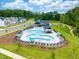 Community amenities showcasing a pool with lounge chairs and umbrellas at 739 Georgia'S Landing Pkwy # 113, Raleigh, NC 27603