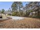 Backyard with deck, trees, and light snow cover at 7516 Fox Rd, Raleigh, NC 27616