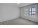 Bright bedroom with carpet flooring and two large windows at 7516 Fox Rd, Raleigh, NC 27616