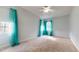 Bright bedroom with teal curtains and neutral carpeting at 7607 Divot Dr, Sanford, NC 27332