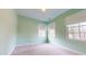 Charming bedroom with light green walls, neutral carpet, and two windows at 7607 Divot Dr, Sanford, NC 27332