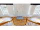 Bright entryway with hardwood floors, showcasing a view of the staircase and access to other rooms at 7607 Divot Dr, Sanford, NC 27332