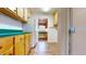 Kitchen with wood cabinets, green countertops, and laundry access at 7607 Divot Dr, Sanford, NC 27332