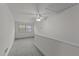 Bright bedroom has neutral carpeting and paint, a ceiling fan, and double-hung windows for great natural light at 801 Williamsboro St, Oxford, NC 27565